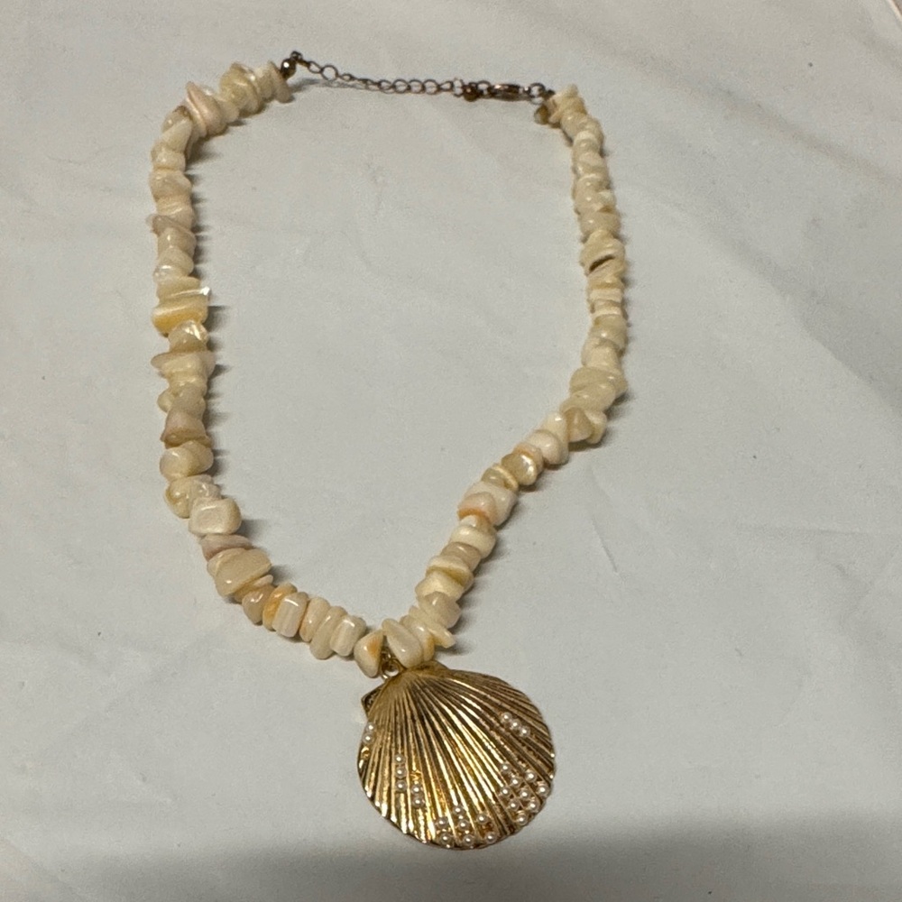 Bohemian-style shell pendant necklace/choker with strand of stone shell chips.